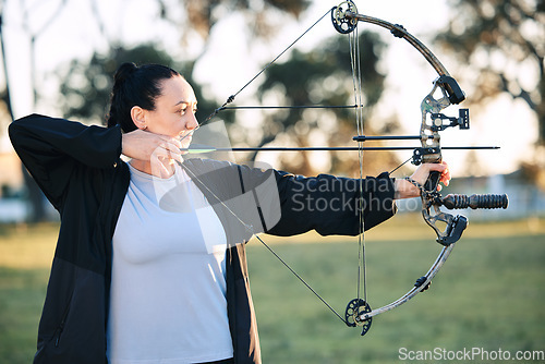 Image of Hobby, learning and woman playing archery as a sport, outdoor activity and game in nature of France. Training, practice and girl with a bow and arrow for sports, competition and shooting at a park