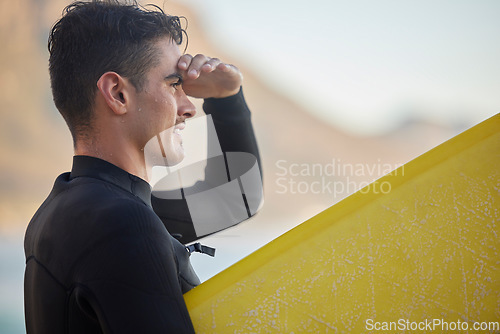 Image of Surfer man, ocean and looking with smile for waves, excited and hand by eyes for view in morning sunshine. Sea athlete profile, surfboard and focus face for fitness, sports and adventure for workout