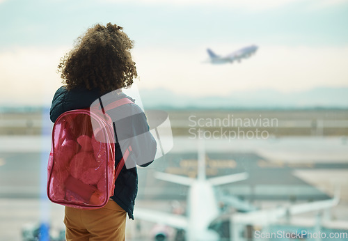 Image of Girl child, looking and airport window for greeting, goodbye and focus for airplane, international transport or travel. Kid, back and watch takeoff by glass for global immigration, young and African