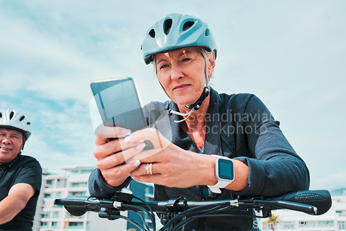 Image of Mature woman, phone or electrical bike helmet in transport location, clean energy or sustainability travel with GPS map. Technology, electric or eco friendly bicycle and mobile, cycling man or couple