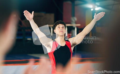 Image of Gymnastics, performance and celebration of man in stadium after stunt for health and wellness. Sports, exercise and workout, training or gymnast celebrate after performing at competition at night.
