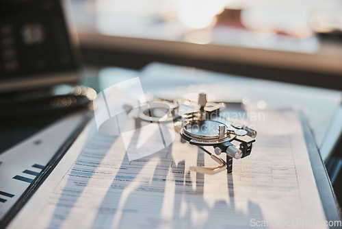 Image of Ophthalmology, test glasses and paperwork on desk for results, diagnosis and analysis for service. Eye care office, documents and phoropter for eyesight health, wellness and exam with medical admin