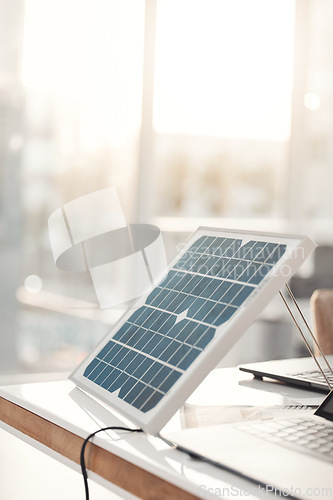 Image of Solar panel, office and design on table for renewable energy, electricity tech or engineering innovation. Photovoltaic, eco friendly or sustainable charge for laptop, job and electric infrastructure