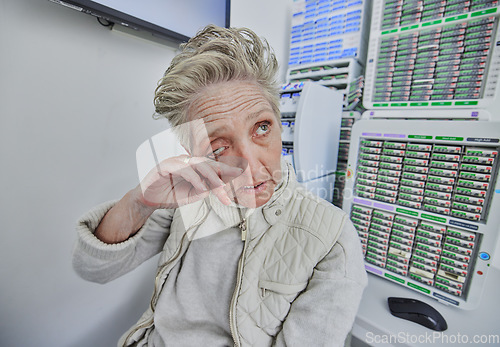 Image of Elderly woman, ophthalmology and eye pain with hand in clinic consultation for vision, wellness and healthcare. Senior patient, visual problem and assessment for eyes, headache and medical solution