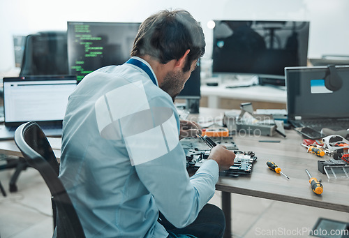 Image of Man, it and technician fixing motherboard in engineering workshop for PC database update. Worker, CPU and circuit board for repair, maintenance or software upgrade in information technology industry