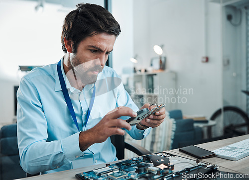 Image of Man, circuit and hard drive in repair workshop for maintenance, computer tech or industry with focus. Technician, motherboard and information technology at desk for electronics, engineering and tools
