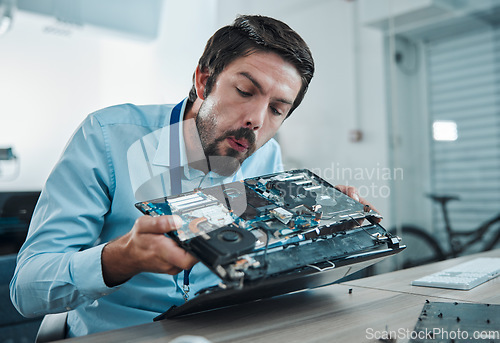 Image of Information technology, laptop circuit repair and man blow hardware dust, electronics or semiconductor. CPU system maintenance, service industry and IT worker fixing motherboard microchip in tech lab