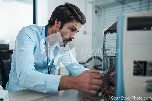 Image of Serious man, it or technician fixing computer, PC or processor in engineering service workshop. Worker, CPU or hardware for repair, maintenance or software upgrade in information technology industry