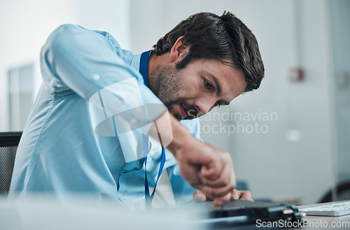 Image of Laptop, service and screwdriver with an engineer or handyman fixing hardware in an IT office. Computer, information technology and maintenance with a male repair professional at work on electronics