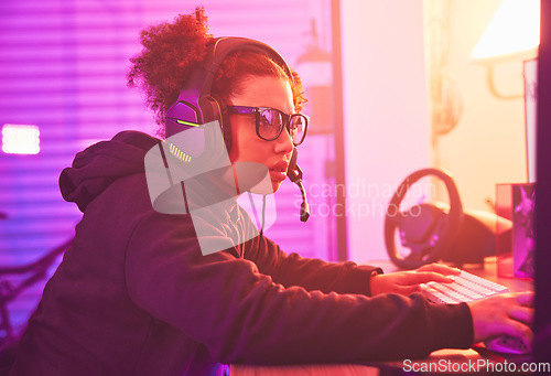 Image of Computer games, young girl and headset in home for esports, online rpg and virtual competition. Female gamer, internet streamer and gaming on headphones in neon lighting, live streaming tech or gen z