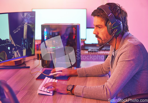 Image of Computer gamer, man and headphones for esports, online games and virtual competition in dark room. Gaming guy, rpg player and video game on headset in neon lighting, pc technology and cyber internet