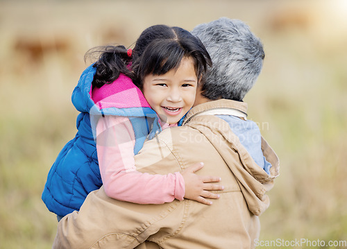 Image of Hug, happy and portrait of a child with grandmother on a farm for bonding, playing and walking. Smile, affection and girl hugging a senior person while on a walk in the countryside for quality time