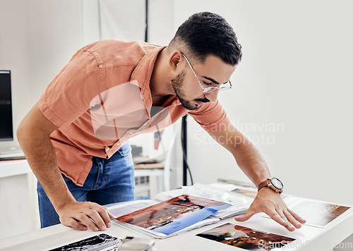 Image of Photographer person looking at photos for photography portfolio, photoshoot results thinking, decision and choice. Professional designer or serious man analysis of images on desk for print catalog