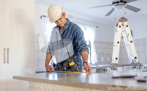 Image of Construction, measurement and handyman doing home repair, renovation and building a counter. Service, contractor and builder busy with house improvement, installation and maintenance in a kitchen