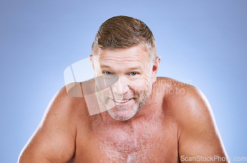 Image of Portrait, skincare and hygiene with a mature man in studio on a blue background for cleaning or beauty. Face, wellness and health with a handsome older male posing to promote natural skin treatment