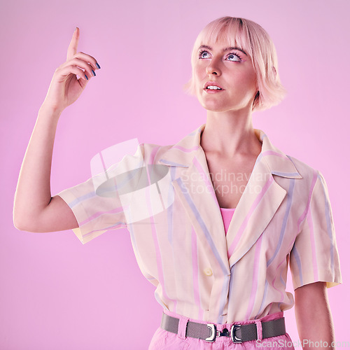 Image of Woman, mockup and pointing up to studio on pink background for advertising wall color. Female model, hands and press information on cyberpunk system, gen z fashion and user network backdrop space