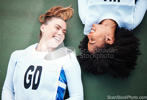 Image of Friends, sports and overhead with women lying on the ground at a court to relax after training. Fitness, team or smile with a happy female athlete and friend resting together while finished exercise