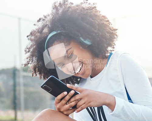 Image of Netball sports, phone music and black woman listening to mp3 radio, audio podcast or playlist song after training workout. Laughing, online digital headphones and athlete streaming funny meme video