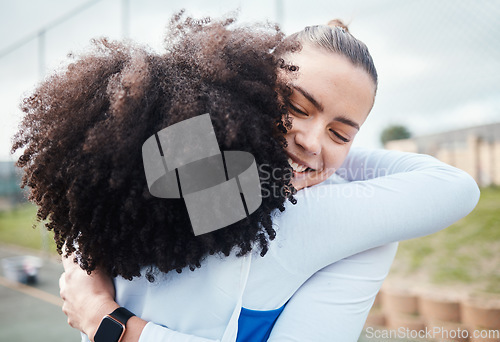 Image of Hug, success or team support in netball training game or match in goals celebration on sports court. Teamwork, fitness friends group or excited athlete girls with happy smile or winning together