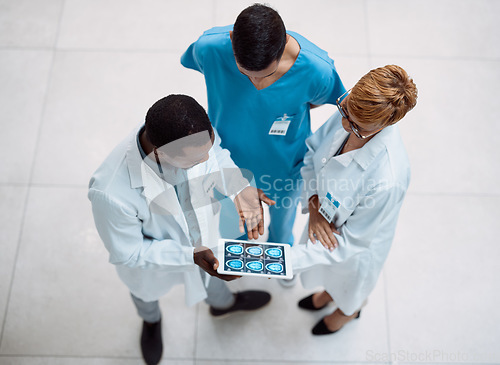 Image of Doctor, tablet and meeting in healthcare above on screen for research, anatomy or surgery analysis. Medical professional team holding touchscreen and brain x ray display in collaboration or planning