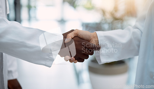 Image of Doctor, handshake and partnership in healthcare, agreement or deal for collaboration, teamwork or unity. Hand of medical professionals shaking hands for meeting, greeting or success in solidarity