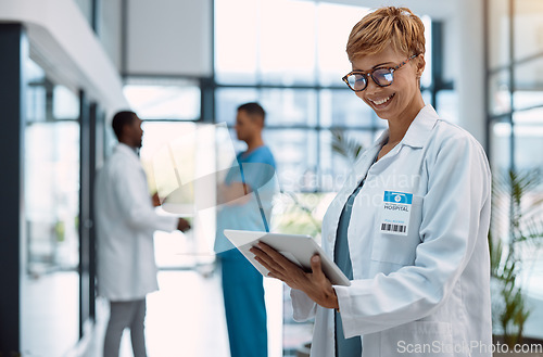 Image of Woman, doctor and tablet in healthcare research at hospital for innovation, software or schedule planning. Happy female medical professional on touchscreen in online search, browsing or communication