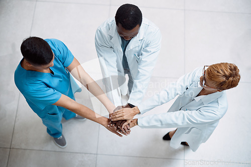 Image of Doctor, meeting and hands together above for collaboration, healthcare or teamwork unity in trust. Top view of doctors piling hand in medical agreement, strategy or partnership for team solidarity