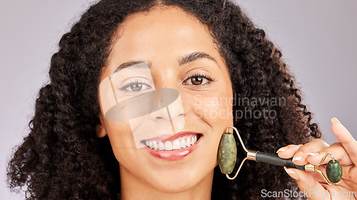 Image of Jade facial roller, portrait and black woman with face skin glow and beauty stone tool in studio. Wellness, dermatology and young model with spa, skincare and happiness from cosmetics treatment