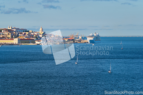 Image of View of Lisbon view over Tagus river with yachts and boats on sunset. Lisbon, Portugal