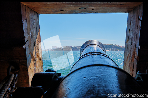 Image of View out of a gunport in hull of the ship on the gun deck over the gun cannon muzzle in