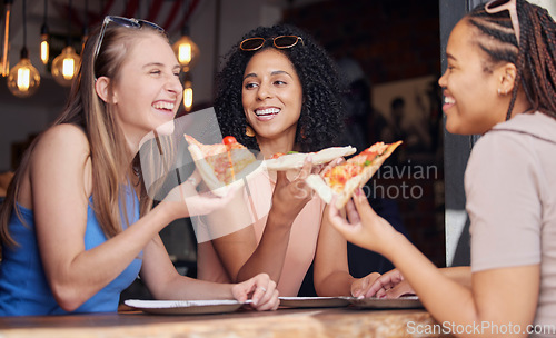 Image of Woman, friends and laughing with pizza for funny joke, meme or conversation together at restaurant. Happy hungry women laugh and smile for fun date, eating or bonding at cafe enjoying Italian food