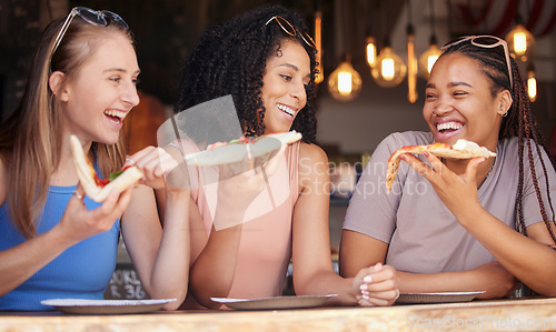 Image of Woman, friends and laughing for pizza, food or eating at funny restaurant together in friendship. Happy hungry women laugh and smile for fun date, socializing or bonding at cafe enjoying Italian meal