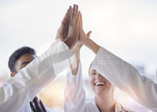 Image of Doctor, group high five and teamwork with hands, celebration and motivation in hospital for healthcare. Man, woman and medic team building with support, solidarity and diversity in clinic for goal