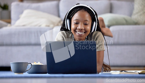 Image of Black woman, student and laptop with smile for elearning, education or entertainment by living room sofa at home. Happy African American female learner smiling on computer lying on lounge floor