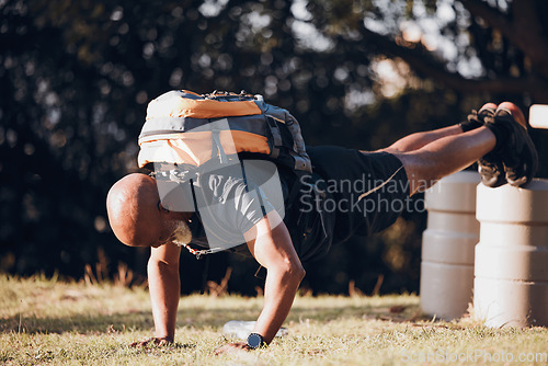 Image of Pushup, strong and black man at a fitness bootcamp for exercise, workout and sports. Active, bodybuilder and athlete doing a cardio challenge, physical activity and strength routine on a field