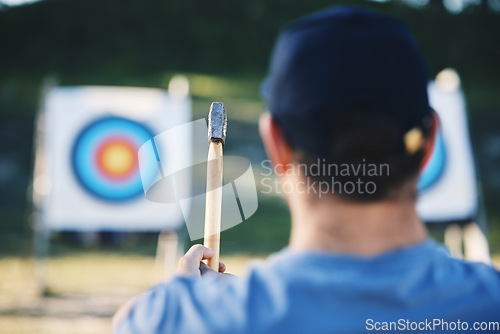 Image of Sports, bullseye and man with axe for target on range for training, exercise and hunting competition. Extreme sport, fitness and male archer aim with tomahawk weapon for practice, games and adventure