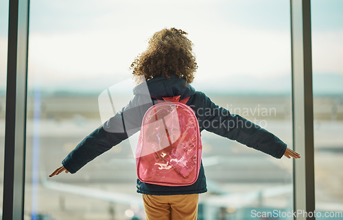 Image of Girl kid, looking and airport window for greeting, goodbye and flying on airplane, international transport or travel. Child, back and watch takeoff by glass for global immigration, young and playing