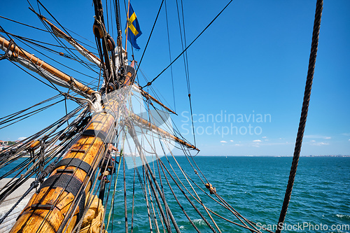 Image of Bowspirit of old wooden sail ship with lots of rope gear