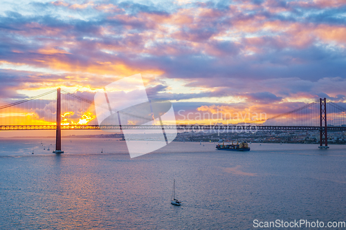 Image of View of 25 de Abril Bridge over Tagus river on sunset. Lisbon, Portugal