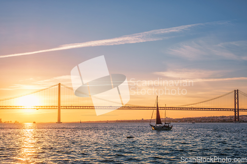 Image of View of 25 de Abril Bridge over Tagus river on sunset. Lisbon, Portugal
