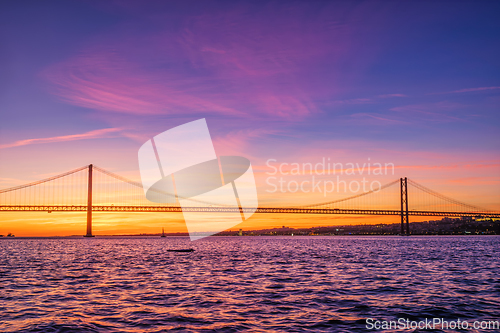 Image of View of 25 de Abril Bridge over Tagus river on sunset. Lisbon, Portugal