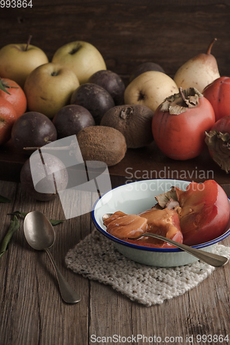 Image of Persimmon fruit on rustic table