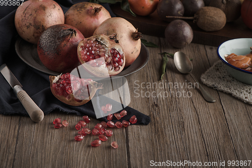 Image of Pomegranate fruit on rustic table