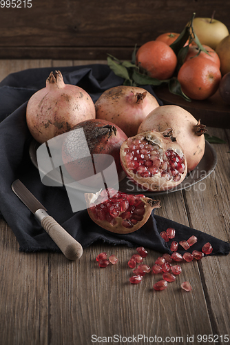 Image of Pomegranate fruit on rustic table