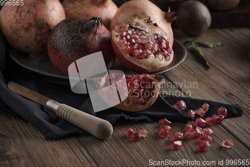 Image of Pomegranate fruit on rustic table