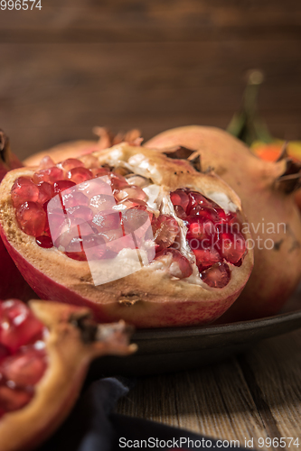 Image of Pomegranate fruit on rustic table