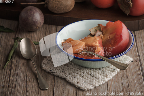 Image of Persimmon fruit on rustic table