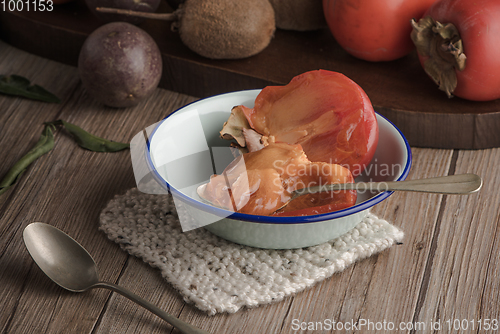 Image of Persimmon fruit on rustic table