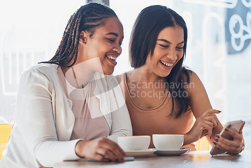 Image of Women friends, coffee shop and phone with smile, happy and laugh at comic meme on social network. Gen z black woman, smartphone and relax in cafe with blog, funny video or texting app ux on internet