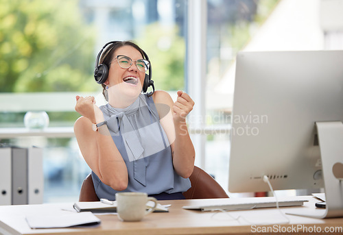 Image of Video call, wow and winner with a business woman in celebration of a goal, target or deal in her office. Virtual meeting, success and motivation with a female employee celebrating an achievement